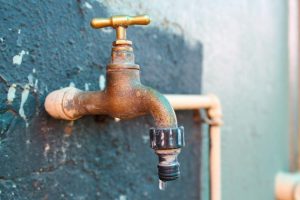 brass faucet dripping water